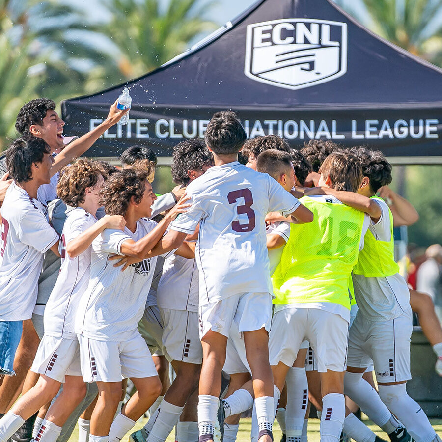 img-boys-ecnl slammers fc boys huddle to celebrate goal